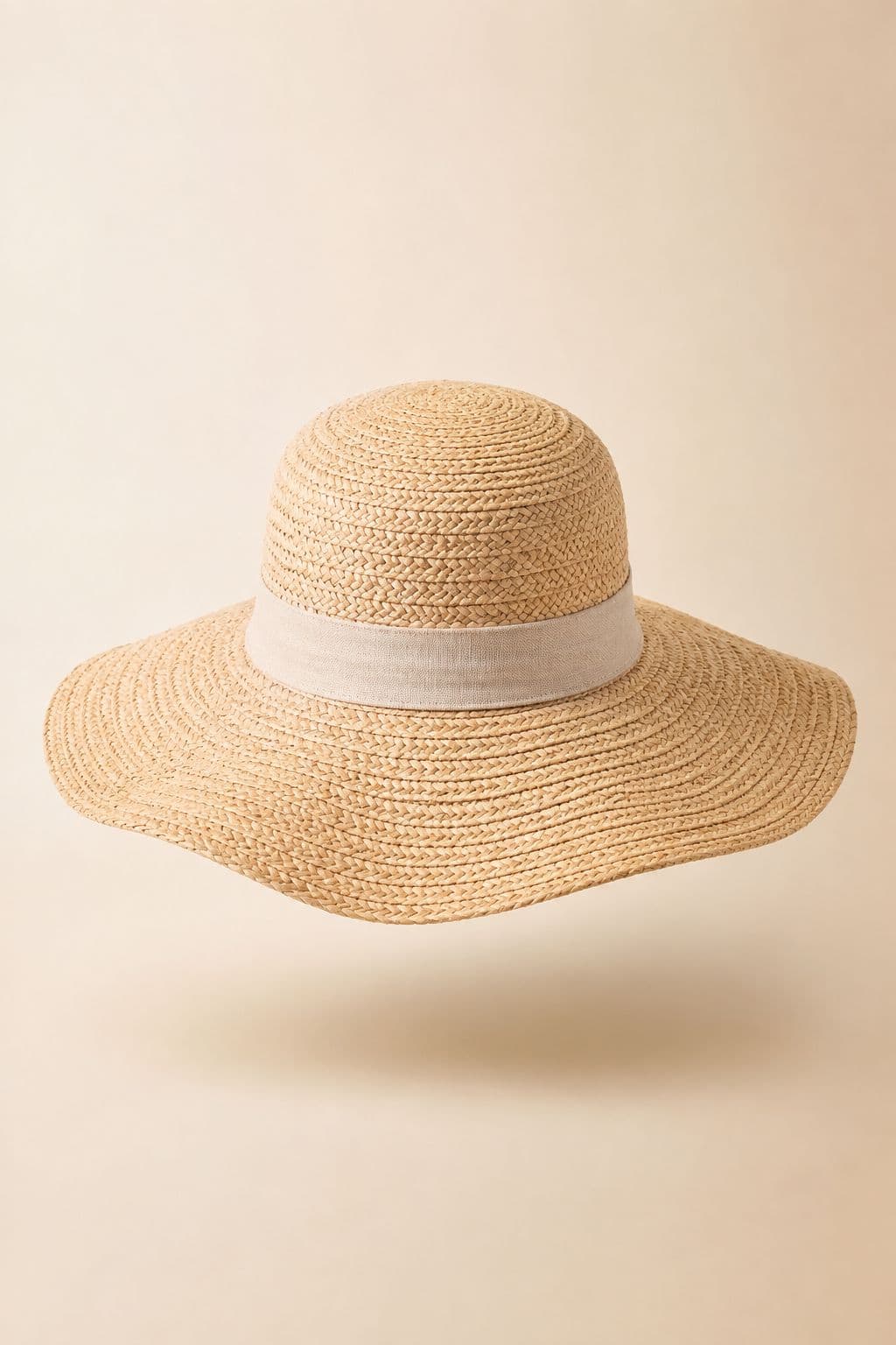 Wide-Brim Sun Hat — A 10 cm packable brim in woven paper straw, with an internal sizing tape.